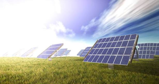 Solar installation team working on commercial building rooftop