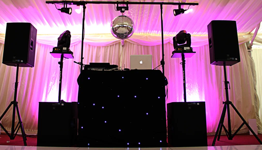 Evening harbor event with stage lighting reflecting on the water